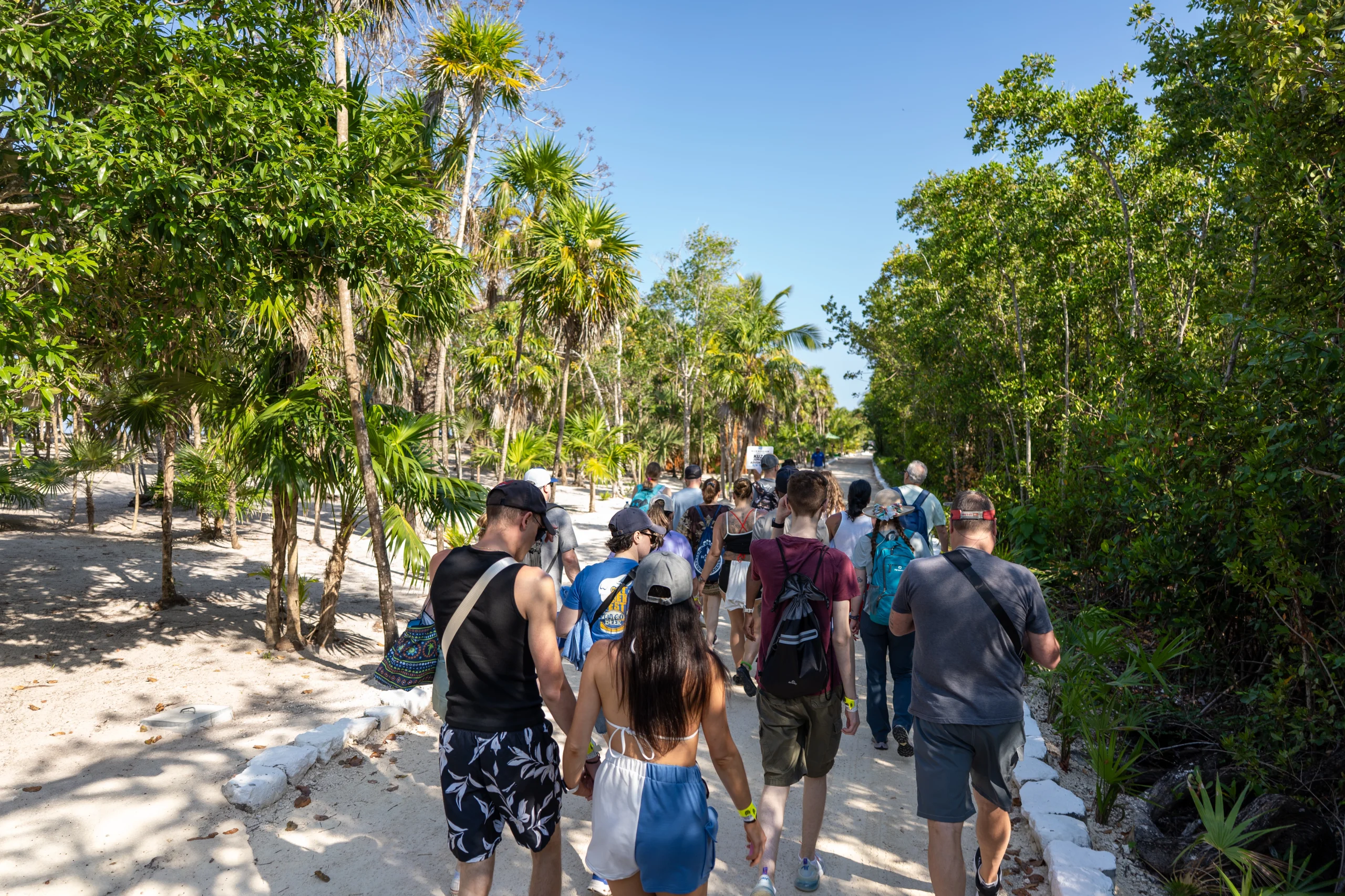 Tourists relaxing on the beach at KUZA Day Pass Cozumel